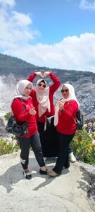 Mahasiswa Pascasarjana Universitas Dayanu Ikhsanuddin angkatan 2024/2025 berfoto bersama saat kegiatan Study Empiris di Kota Bandung, dengan latar belakang pegunungan dan suasana cerah, mengenakan seragam kaus merah dan memegang spanduk kegiatan.